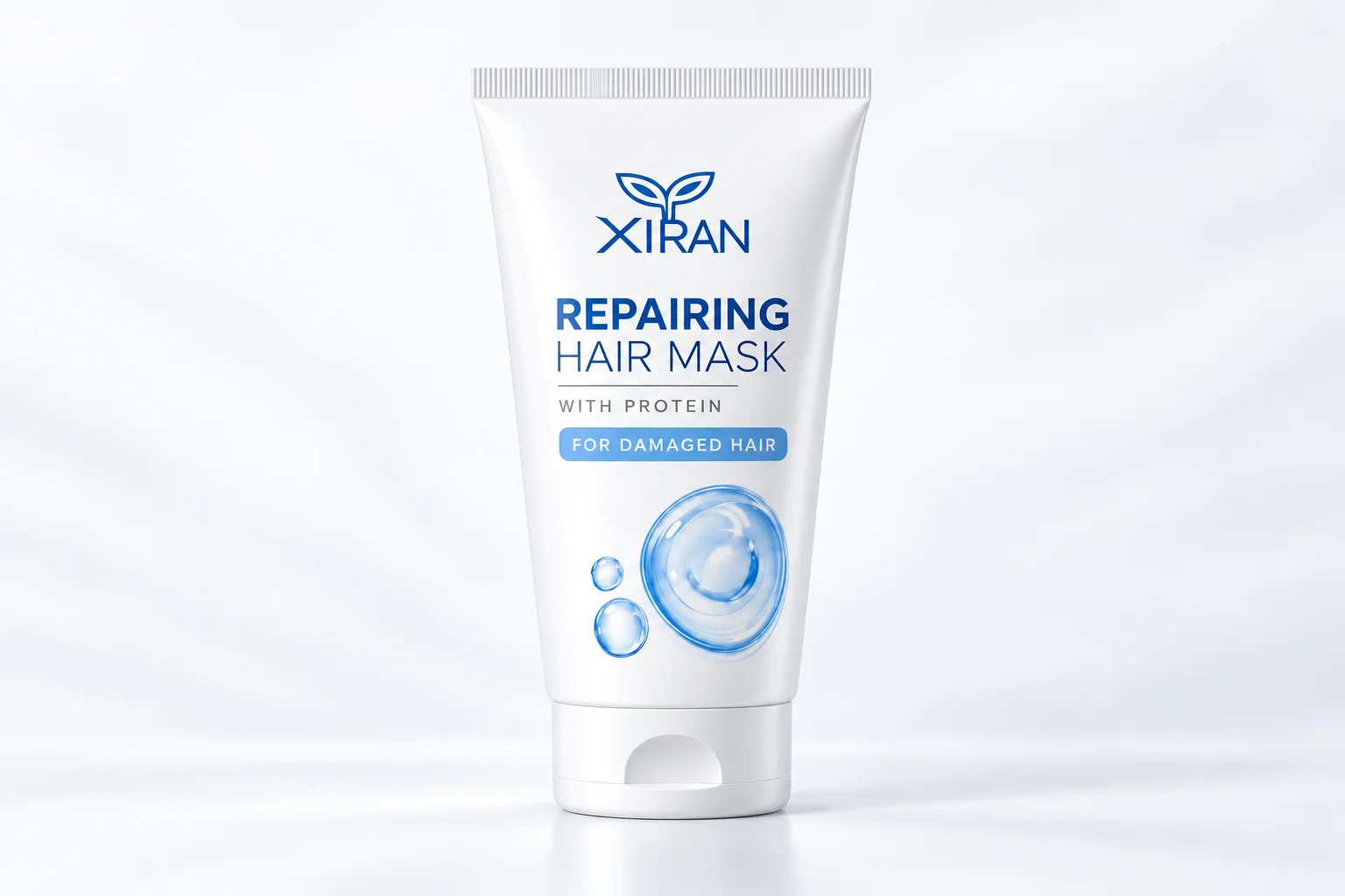 A tube of XIRAN repairing hair mask with protein for damaged hair, featuring a minimal white and blue design on a light background.